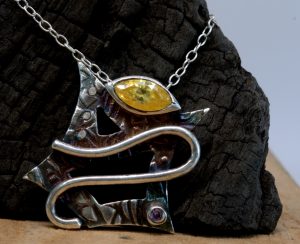 The front of a sterling silver shield necklace