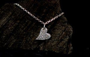 The front of a sterling silver heart anklet