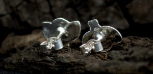 The back of two sterling silver bee stud earrings