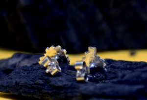 The back of two sterling silver sheep earring studs